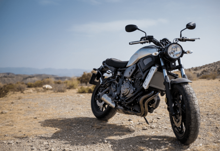 black motorcyle in the foreground on the beach