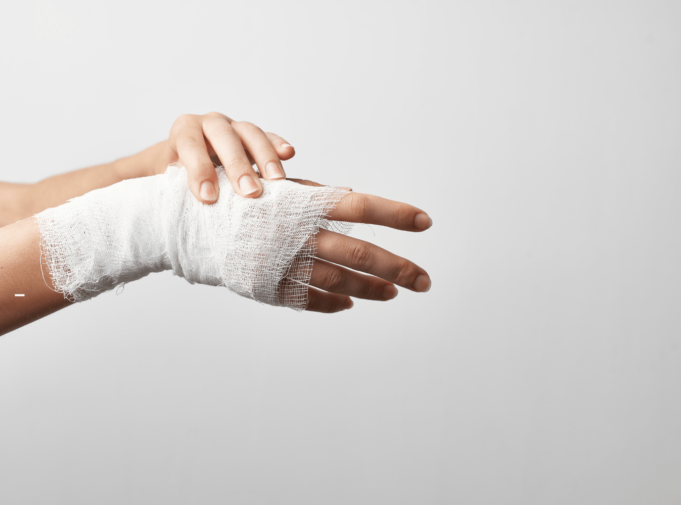 injured hand wrapped in medical gauze