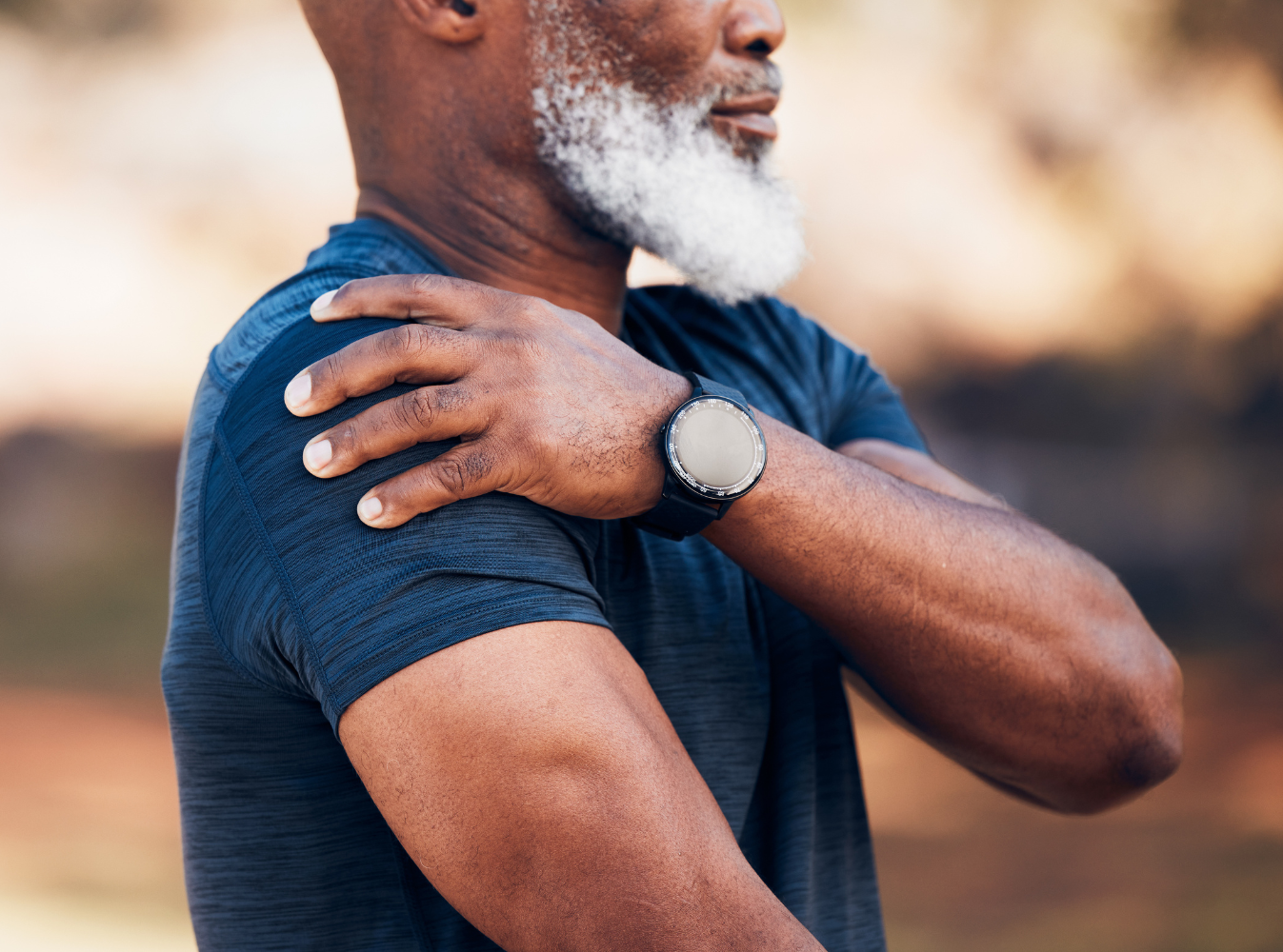 a man holding his shoulder indicating pain