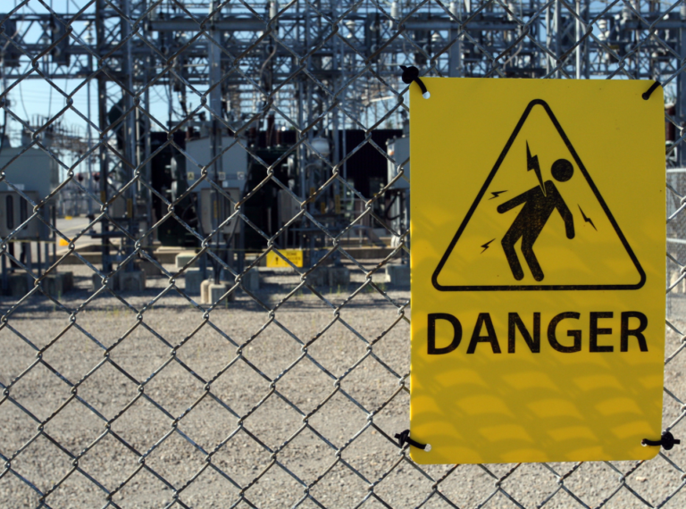 electrocution warning sign on a fence