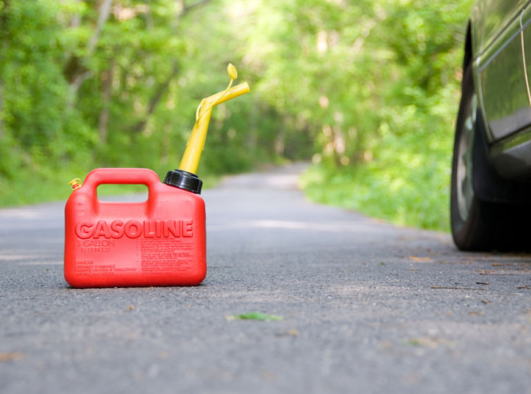 gas can on the road next to a car