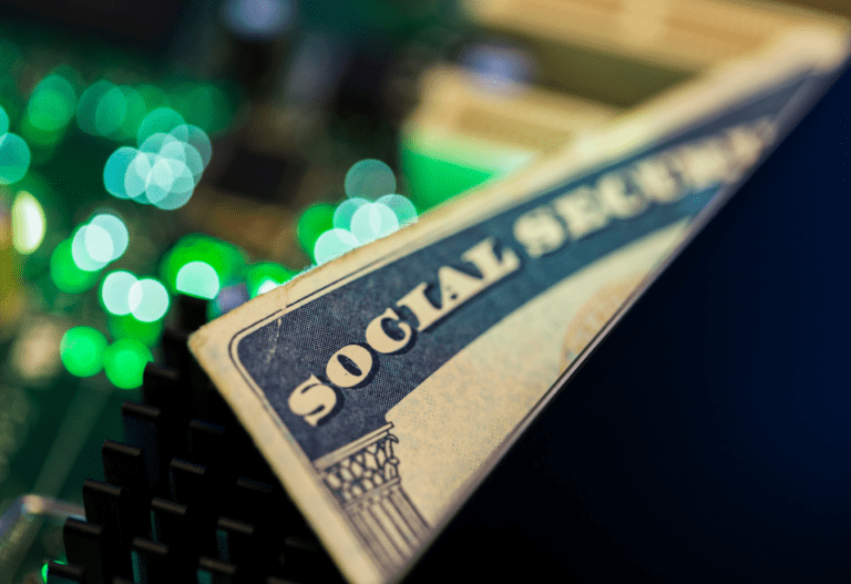 a social security card peeking out of a black wallet, green lights in the background