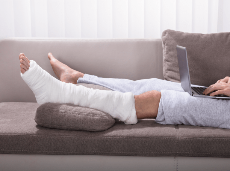 a person's broken leg elevated on a couch