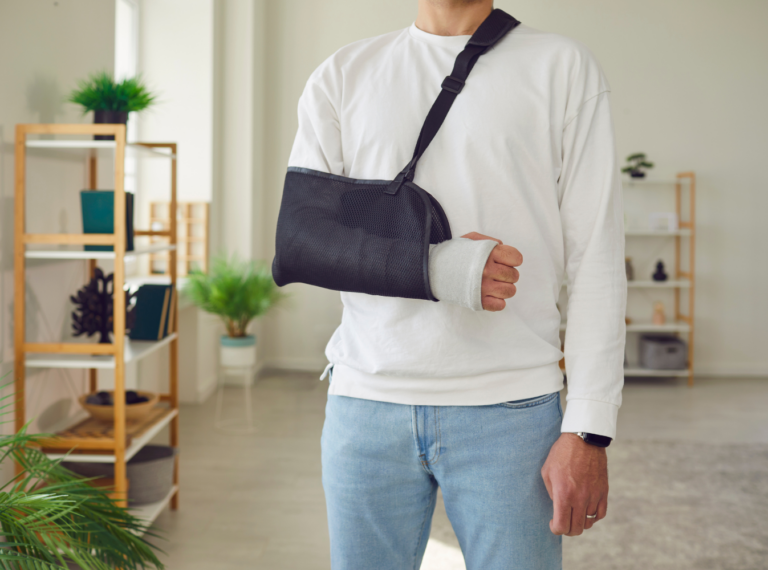 person with a broken arm in a cast and sling