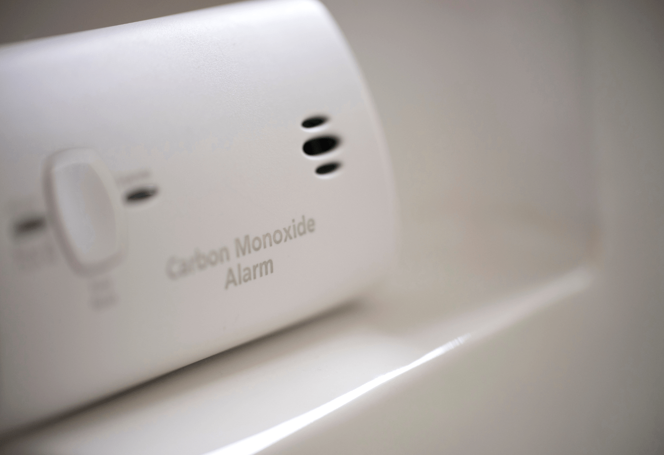 white carbon monoxide detector up close