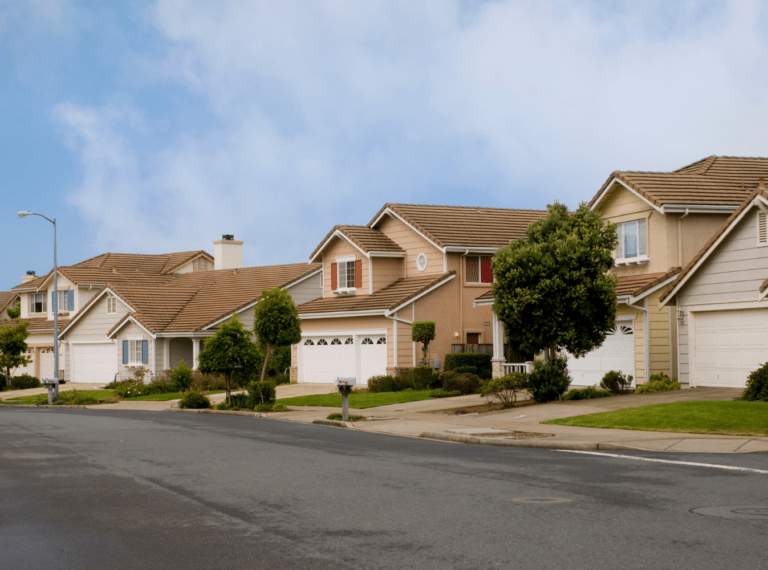 A residential neighborhood street with three houses