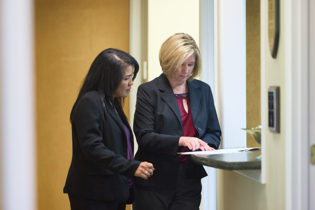 two people looking at a document