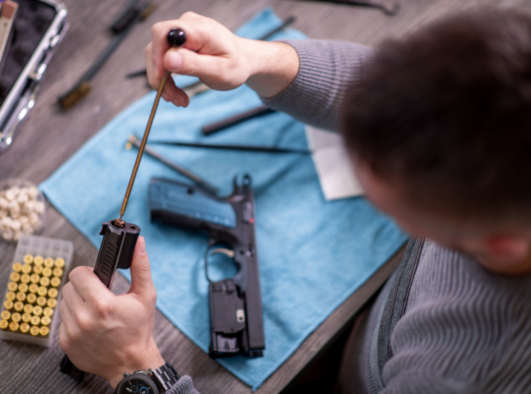 a person cleaning a gun