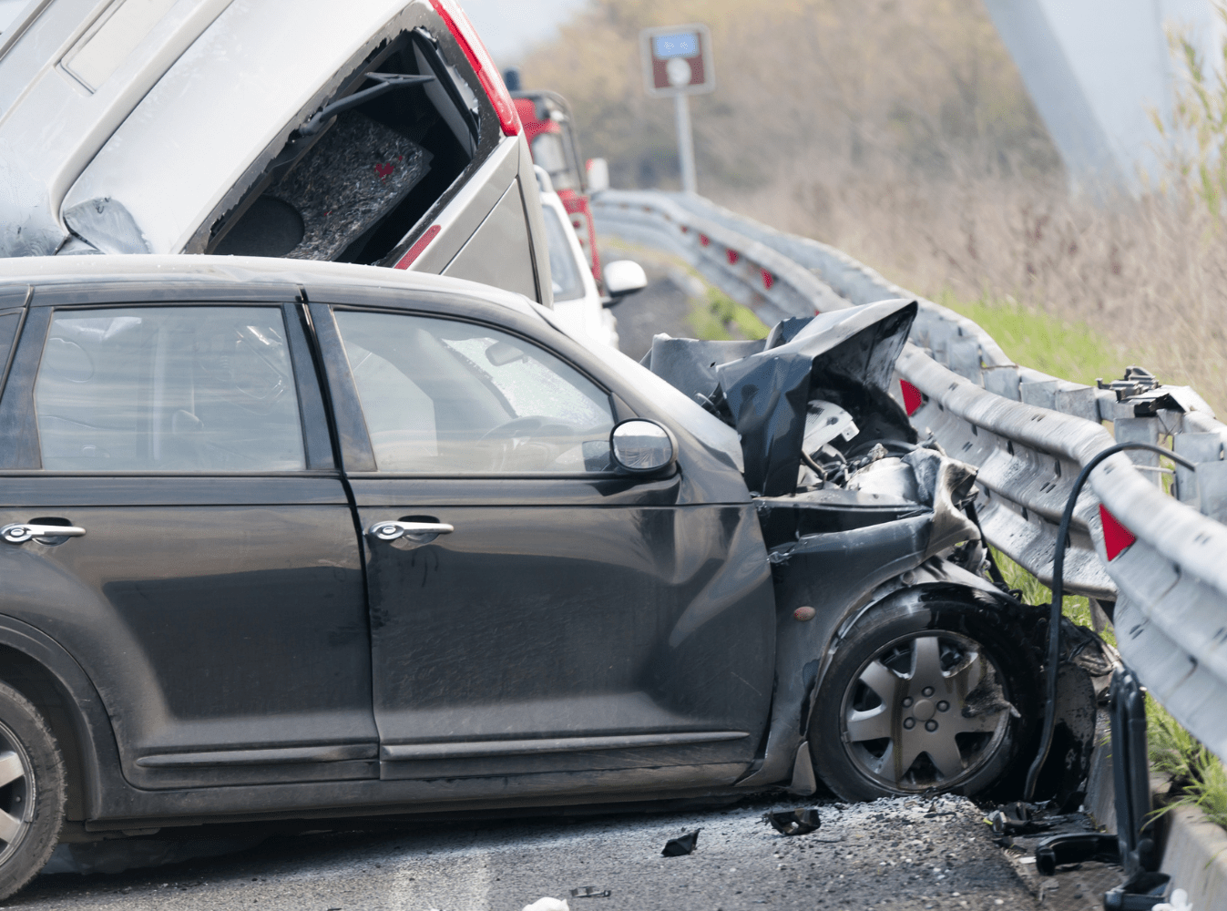 image of a black car crashed into a guard rail