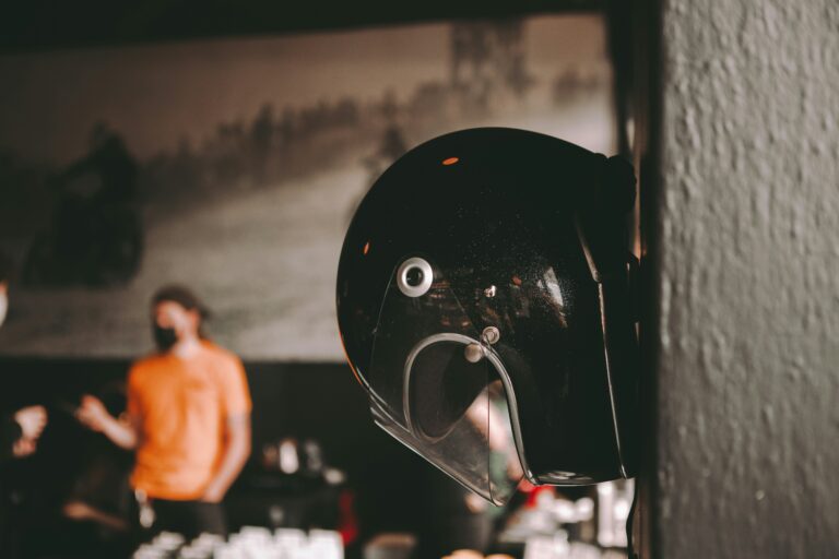 A motorcycle helmet hung up on a bar wall.