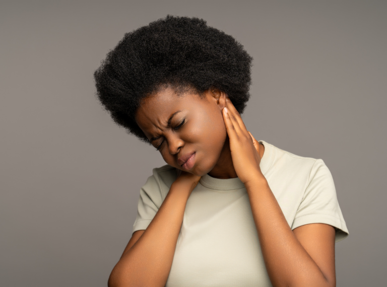 a woman holding her neck indicating nerve pain